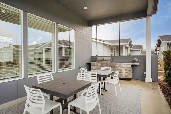 Outdoor grilling station at Villas at 28th Apartments with modern amenities