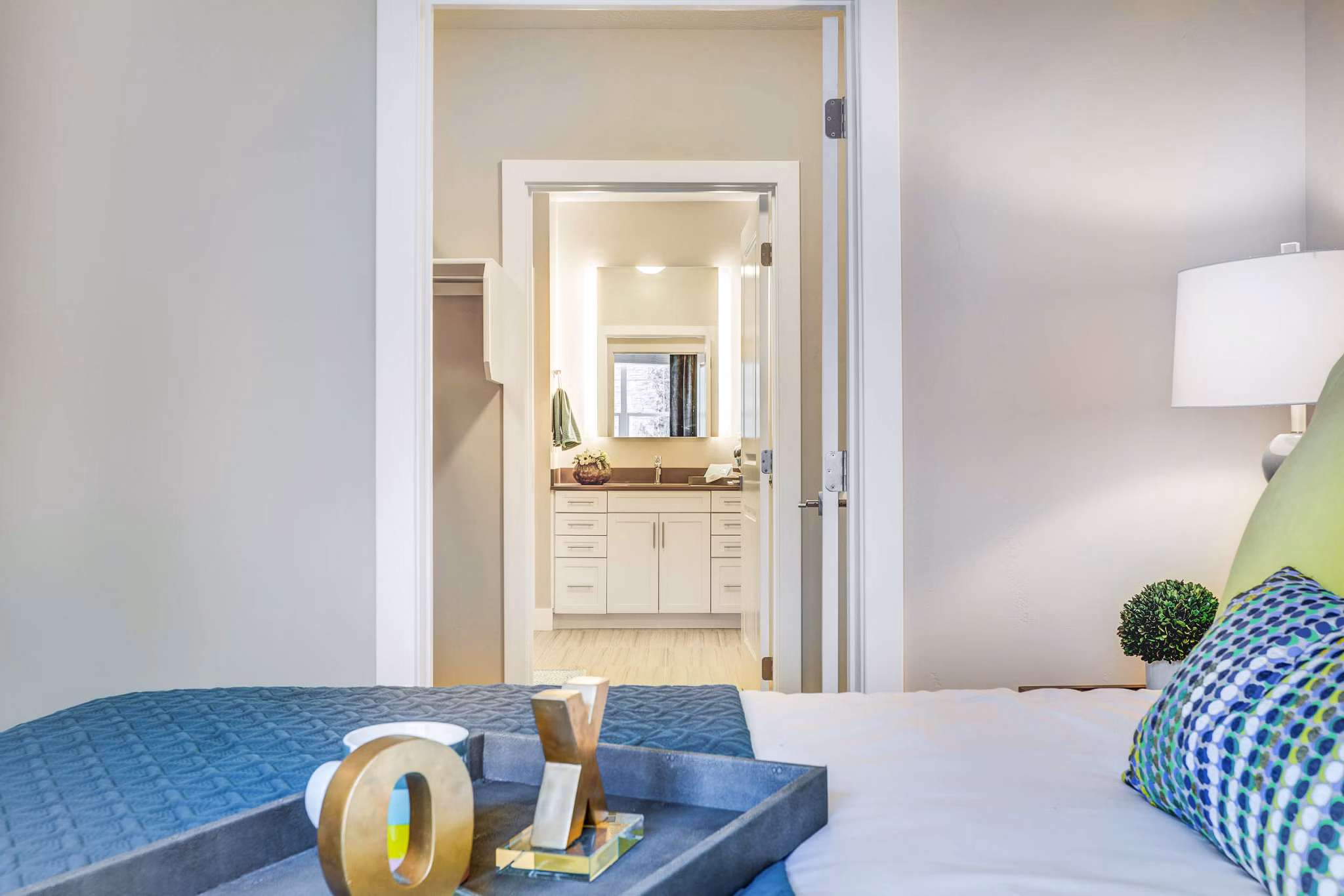 Bedroom with modern furnishings and large window at Incline at Anthem Apartments, offering a luxurious and comfortable living experience
