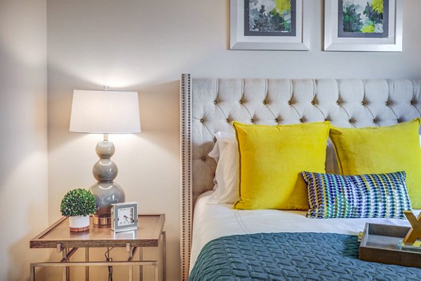 Bedroom featuring modern decor and large windows at Incline at Anthem Apartments