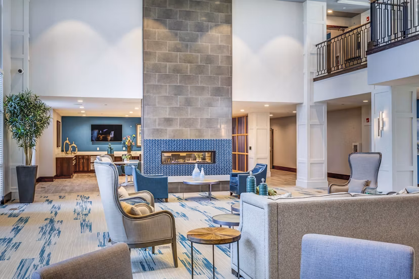 Clubhouse lobby with modern decor and seating area at Incline at Anthem Apartments
