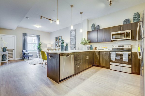 Modern kitchen with granite countertops and stainless steel appliances at Incline at Anthem Apartments