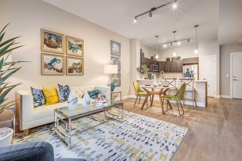 Contemporary living room at Incline at Anthem Apartments with plush seating and large windows