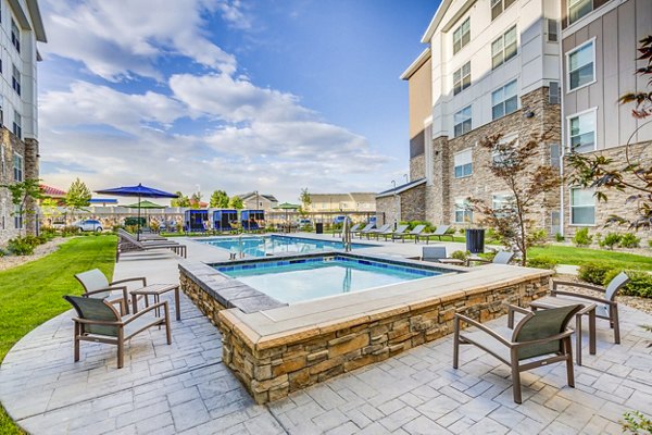 Inviting outdoor pool with lounge chairs at Incline at Anthem Apartments, perfect for relaxation and leisure activities in a luxury environment
