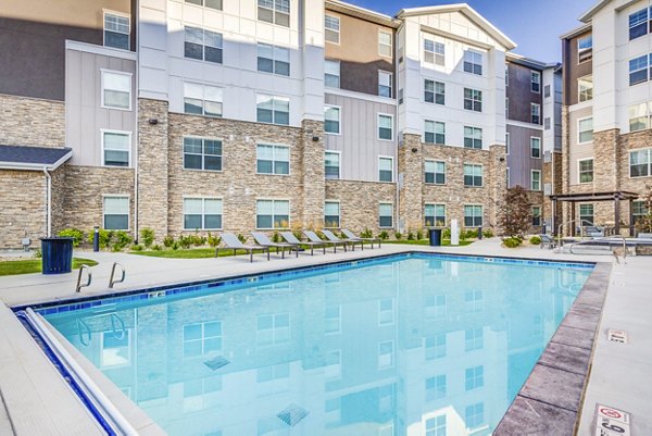 Resort-style pool with lounging areas at Incline at Anthem Apartments