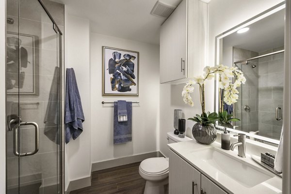 Modern bathroom featuring dual sinks and sleek fixtures at Derby Apartments in the Greystar luxury community