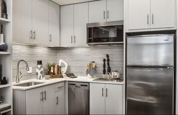 Modern kitchen with stainless steel appliances in Derby Apartments