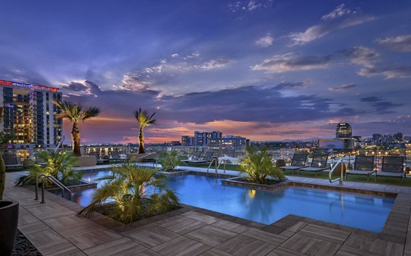 Resort-style pool with lounge chairs at Derby Apartments, offering luxury living spaces by Greystar