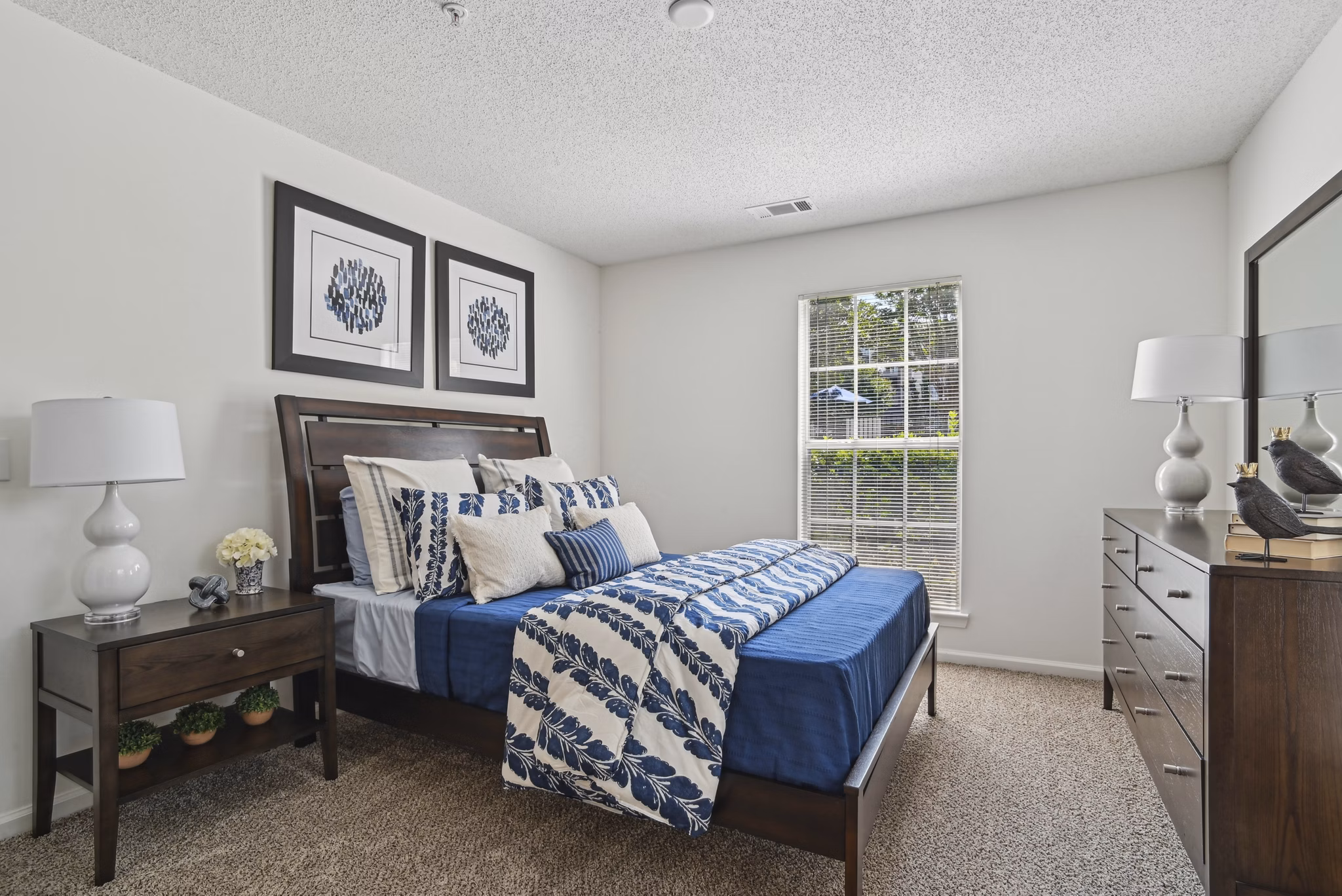 Spacious bedroom with large windows and modern furnishings at The Vinings at Duncan Chapel Apartments