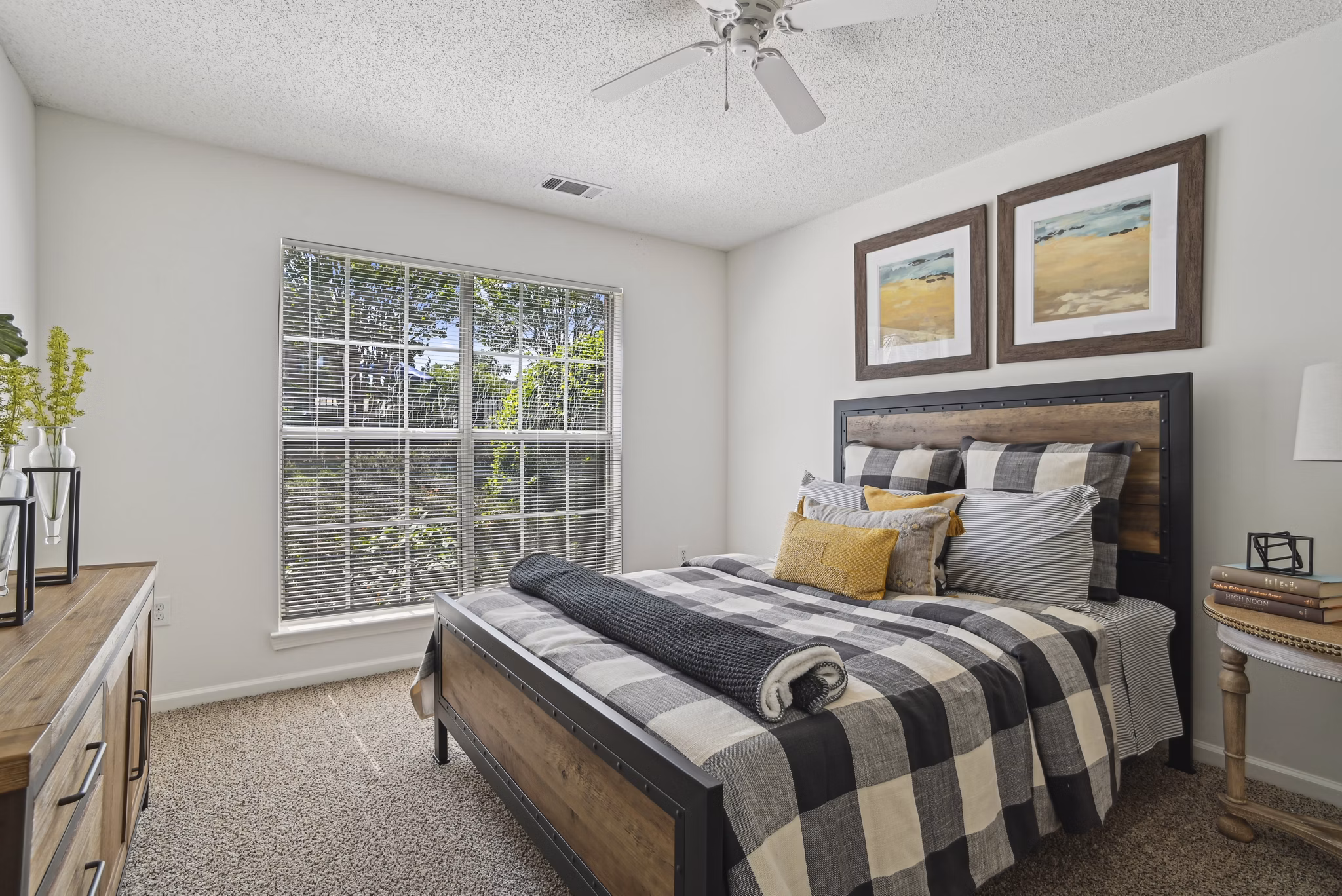 Bedroom featuring elegant decor and large windows at The Vinings at Duncan Chapel Apartments