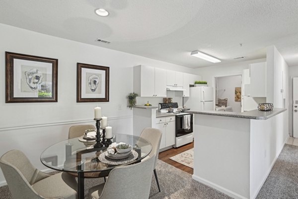 Modern dining area with elegant lighting at The Vinings at Duncan Chapel Apartments