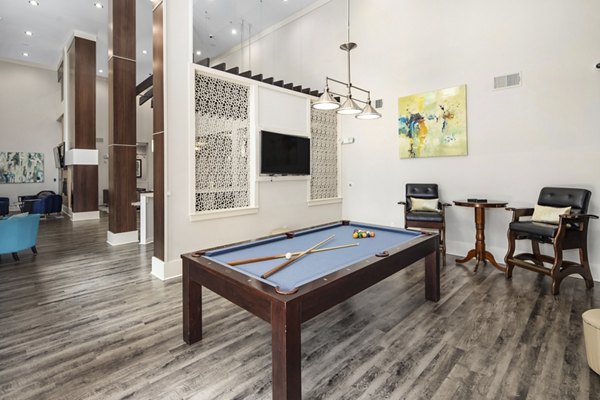 Modern clubhouse with lounge seating and billiards at Avanti Brookhaven Apartments