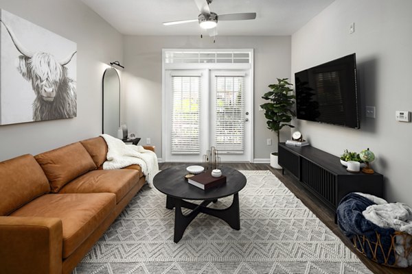 Modern living room with sleek furniture and natural light at Avanti Brookhaven Apartments