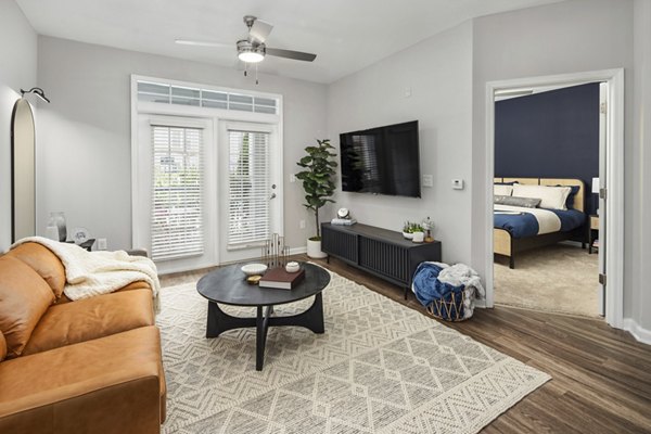 Contemporary living room featuring modern decor and large windows in Avanti Brookhaven Apartments