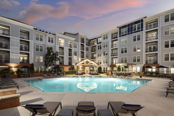 Luxurious swimming pool at Avanti Brookhaven Apartments, featuring poolside lounging and landscaped surroundings