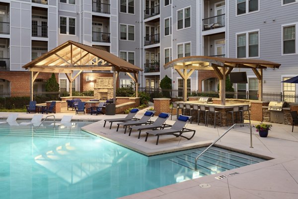 Resort-style pool with sun loungers at Avanti Brookhaven Apartments