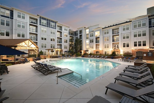 Outdoor pool at Avanti Brookhaven Apartments offering a luxury swimming experience in a stylish setting