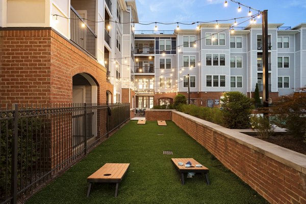 Serene recreational area featuring lush greenery and seating at Avanti Brookhaven Apartments