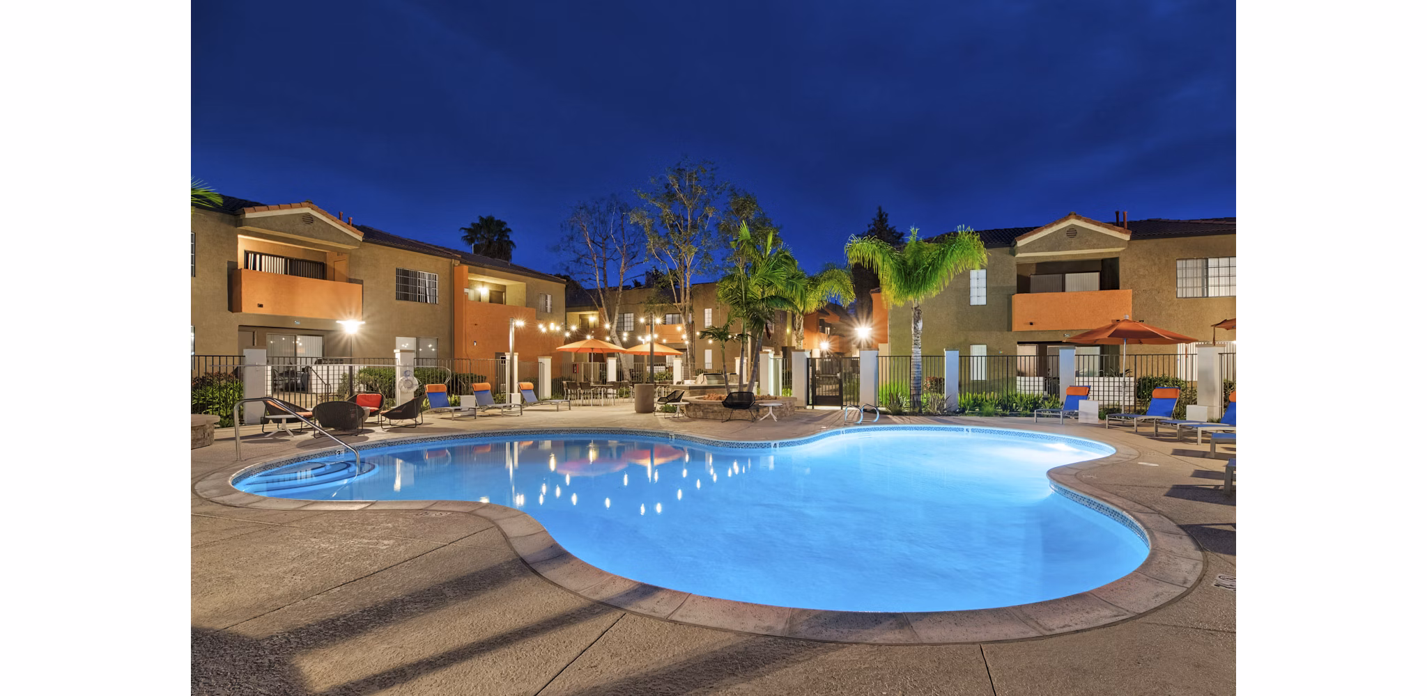Outdoor pool surrounded by lush landscaping at The Ranch at Moorpark Apartments