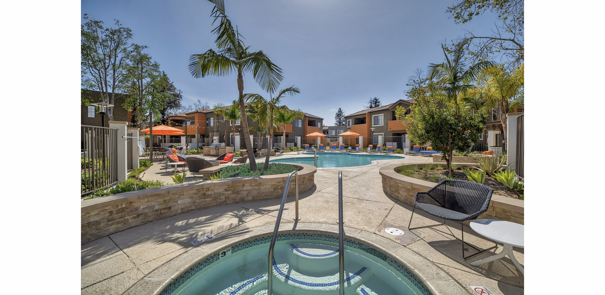 Relaxing pool area with lounge chairs at The Ranch at Moorpark Apartments, offering a luxury lifestyle experience