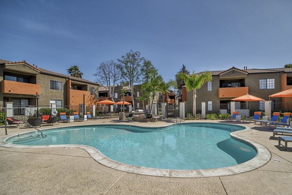 Resort-style swimming pool with lounge chairs at The Ranch at Moorpark Apartments