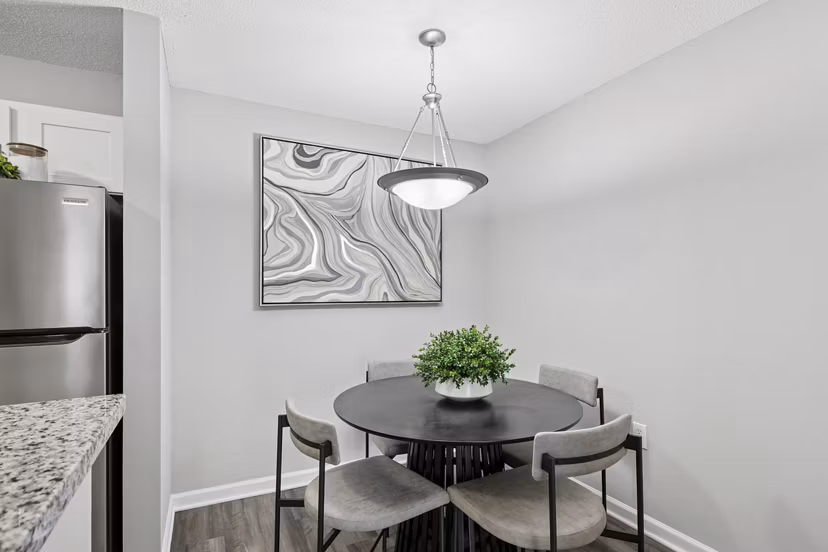 Dining room with modern decor and elegant lighting at Fieldstone Apartment Homes