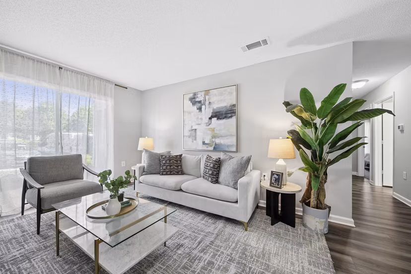 Open-concept living room with modern decor and natural light at Fieldstone Apartment Homes