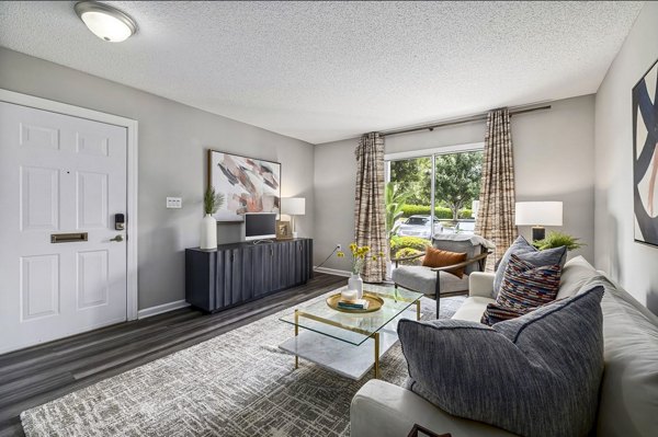 Open-concept living room with modern decor and natural light at Fieldstone Apartment Homes