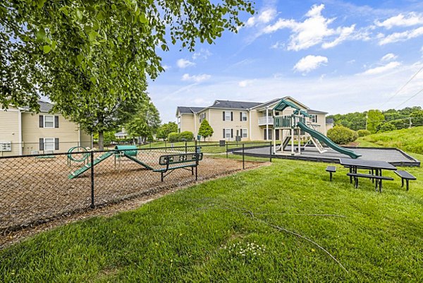Playground with modern equipment at Fieldstone Apartment Homes offering family-friendly amenities