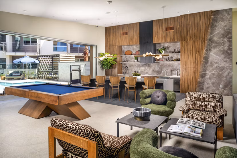 Modern clubhouse featuring plush seating and communal workspaces at Triton Encinitas Apartments