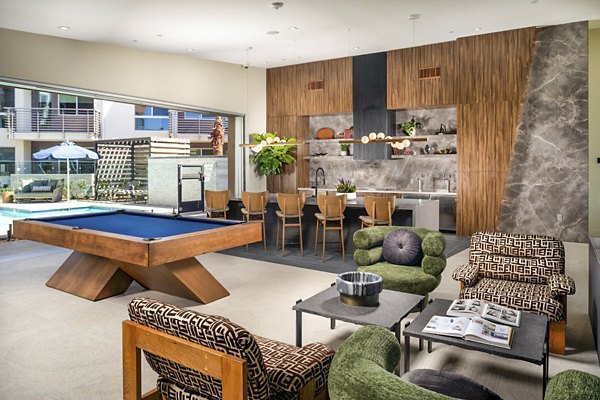 Modern clubhouse featuring plush seating and communal workspaces at Triton Encinitas Apartments