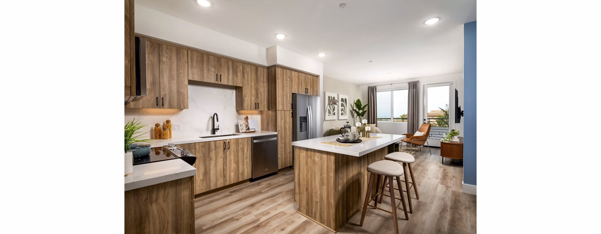 Modern kitchen with stainless steel appliances and granite countertops at Triton Encinitas Apartments, luxury living in California