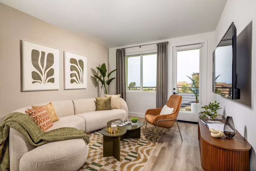 Cozy living room with modern decor and natural light at Triton Encinitas Apartments
