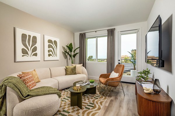 Cozy living room with modern decor and natural light at Triton Encinitas Apartments