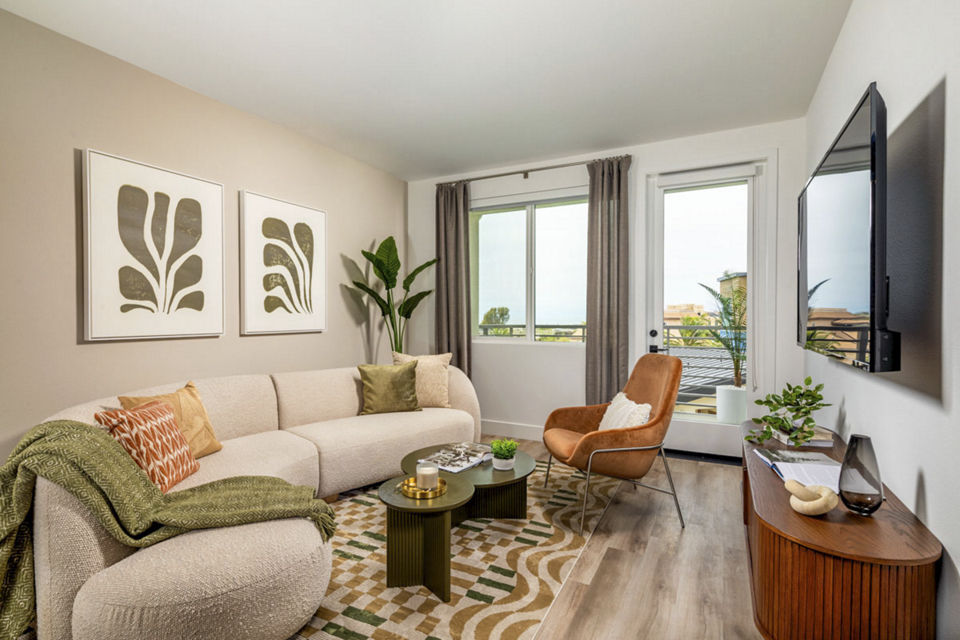 Cozy living room with modern decor and natural light at Triton Encinitas Apartments
