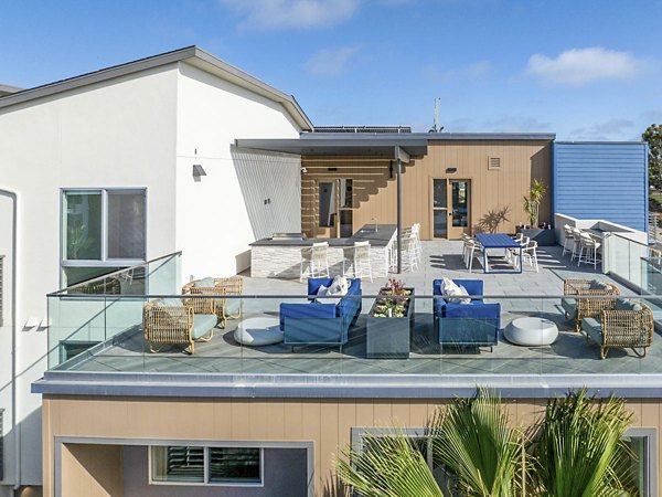 Outdoor patio with cozy seating and ocean views at Triton Encinitas Apartments