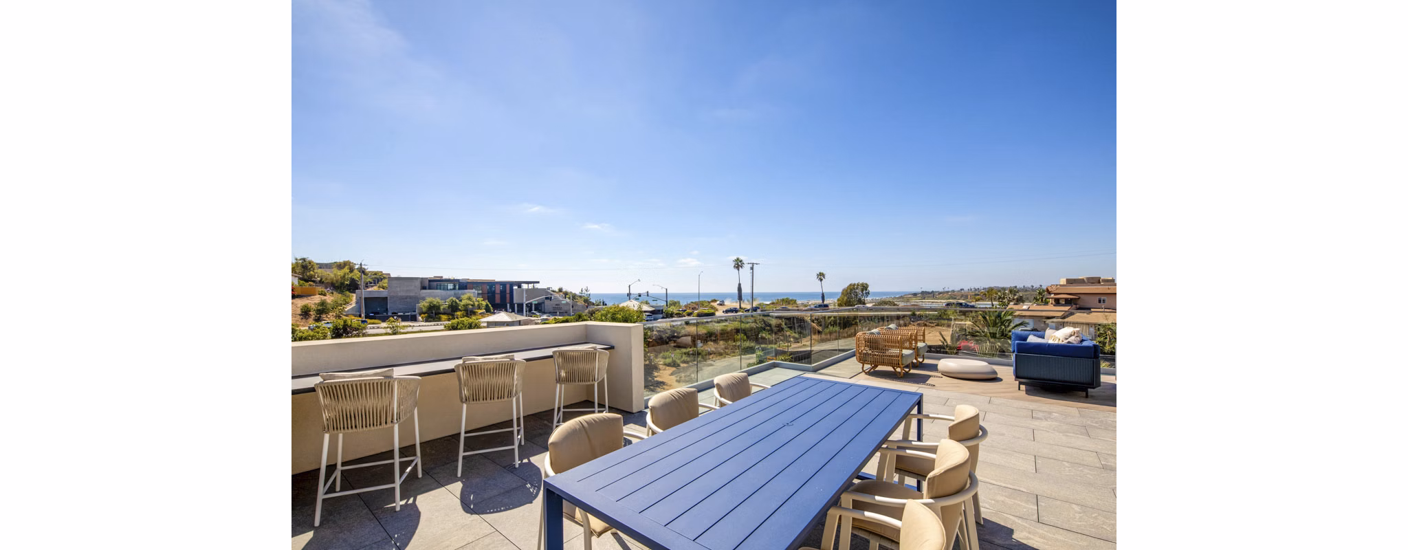 Patio with cozy seating and ocean views at Triton Encinitas Apartments, luxury living by the coast in the vibrant Encinitas community