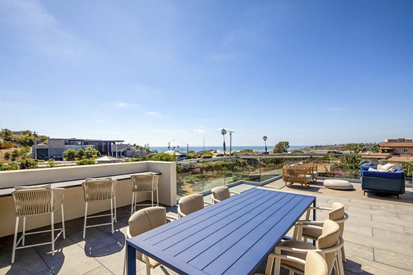 Patio with cozy seating and ocean views at Triton Encinitas Apartments, luxury living by the coast in the vibrant Encinitas community