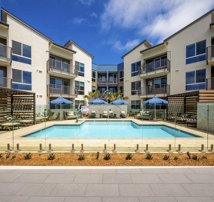 Pool with resort-style seating at Triton Encinitas Apartments offering luxury living