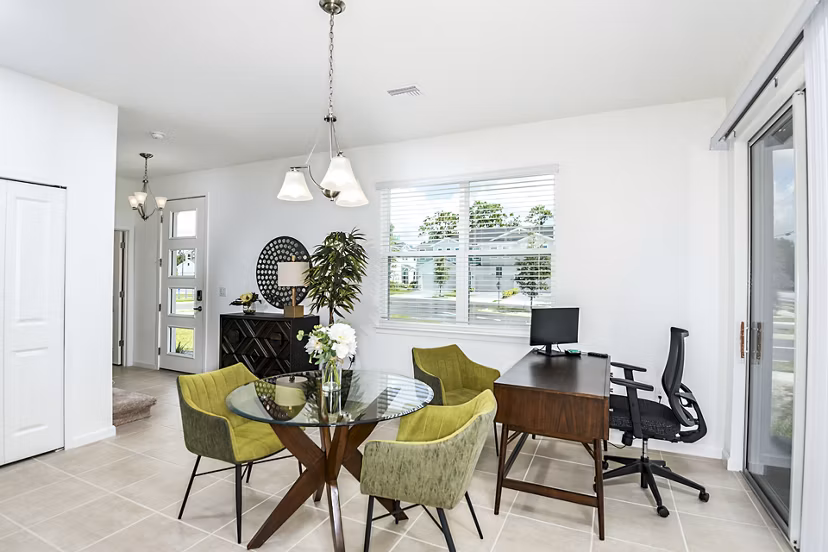 Dining room and home office combo at Alexander Park Apartments with modern decor and ample natural light