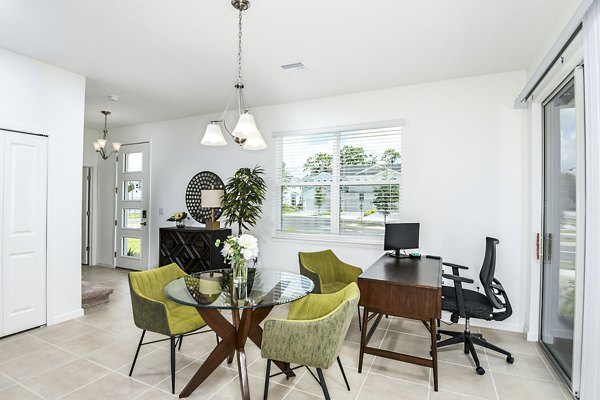 Dining room and home office combo at Alexander Park Apartments with modern decor and ample natural light