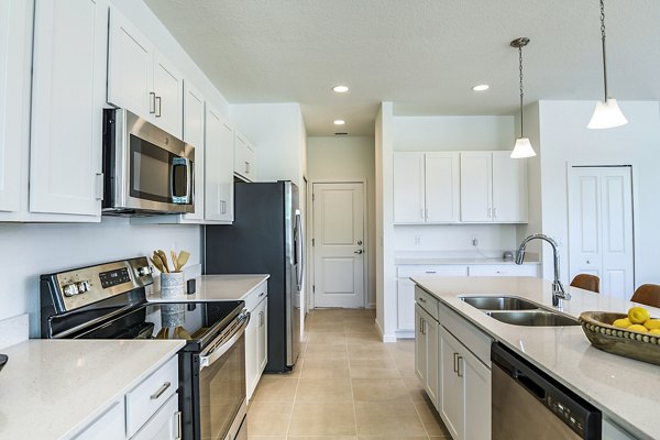 Modern kitchen with granite countertops and stainless steel appliances at Alexander Park Apartments