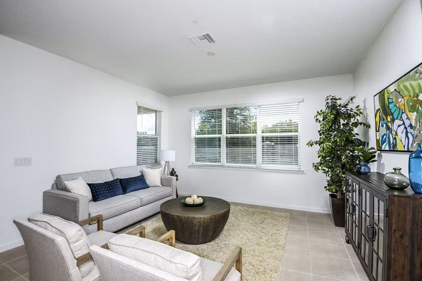 Spacious living room featuring modern decor and natural lighting at Alexander Park Apartments