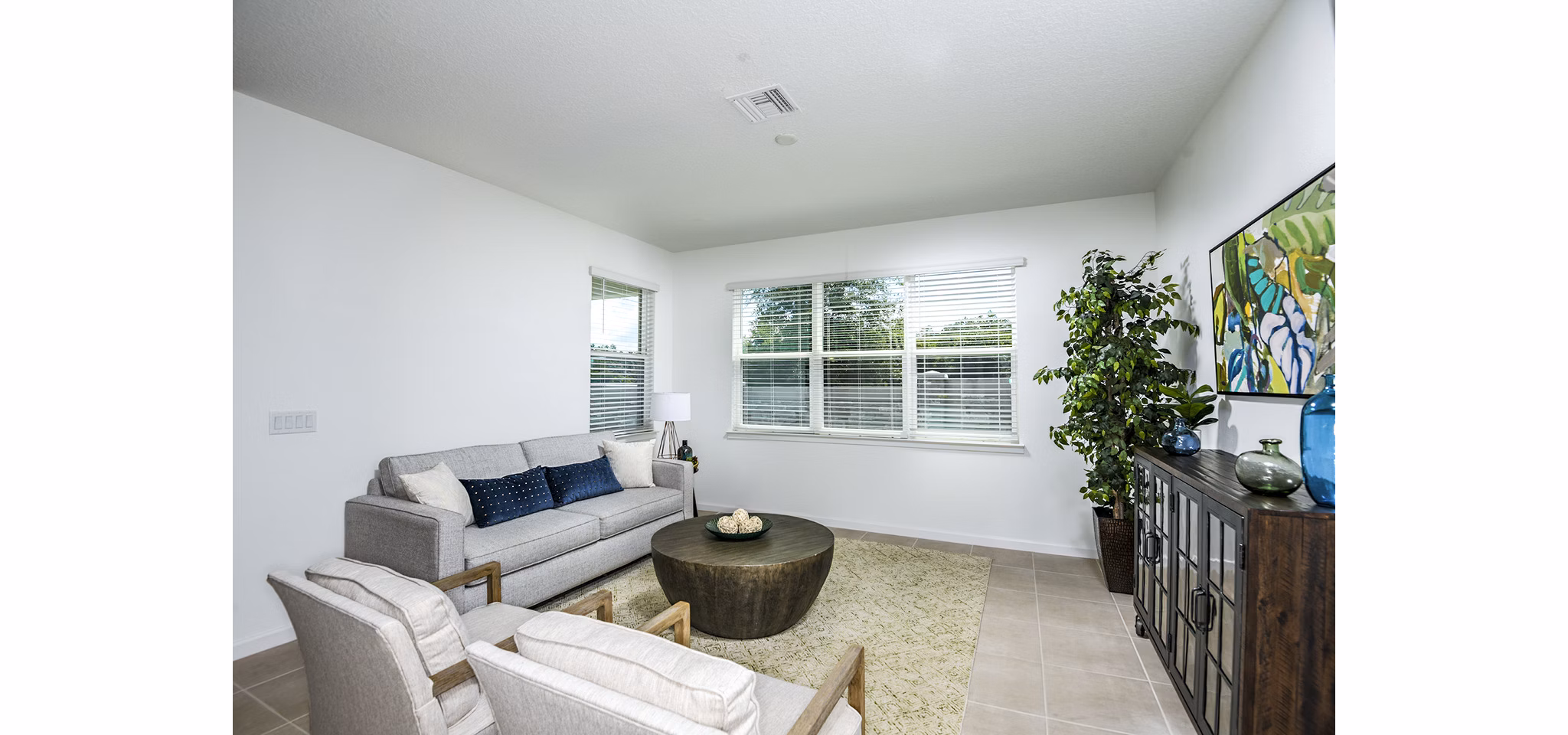 Spacious living room featuring modern decor and natural lighting at Alexander Park Apartments