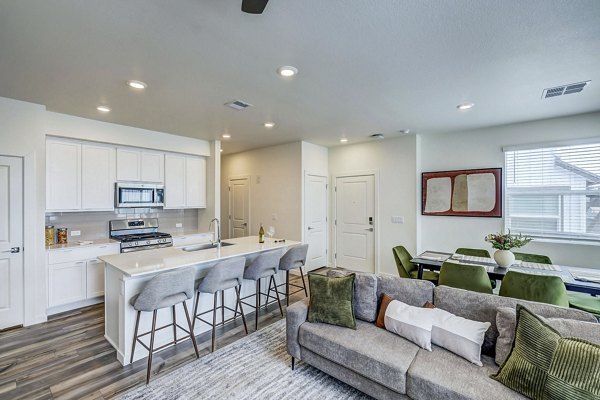 kitchen and living room at VellaTerra Apartment