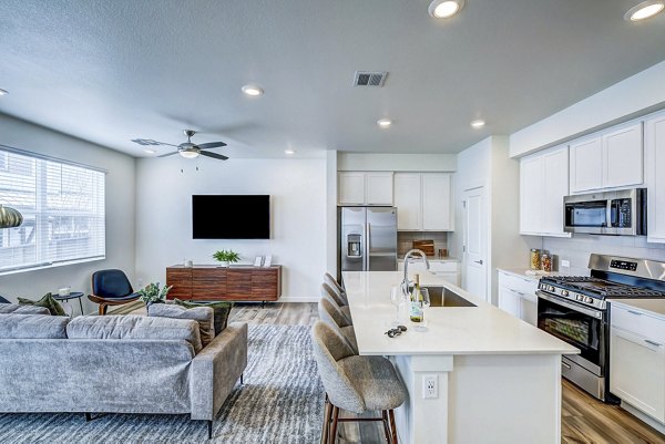 kitchen and living room at VellaTerra Apartment