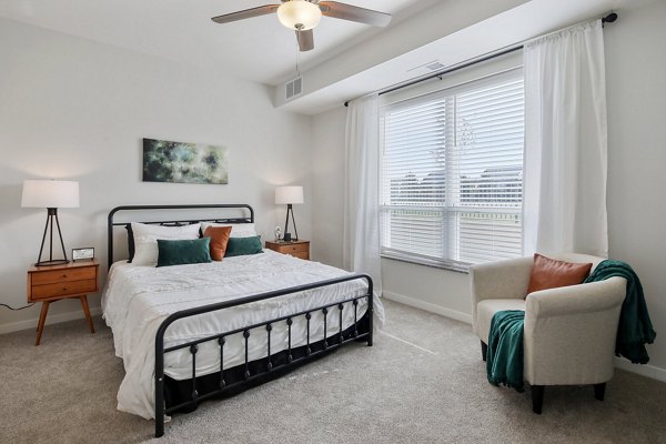 Cozy bedroom with modern decor at Arasan Apartments offering luxury living in a prime location