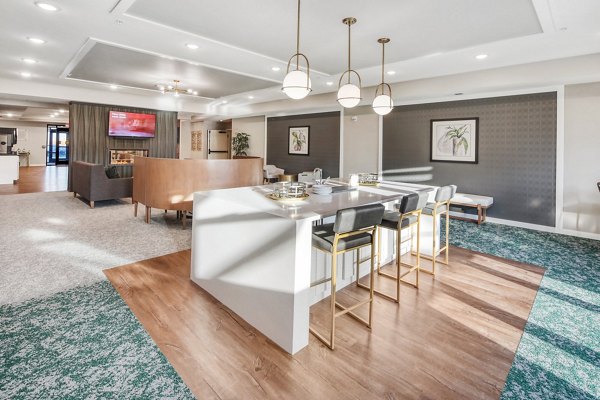 Clubhouse interior featuring modern design and ample seating at Arasan Apartments, a luxury community
