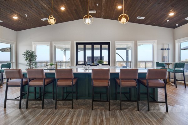 Chic clubhouse with modern furnishings at Arasan Apartments, ideal for social gatherings and relaxation