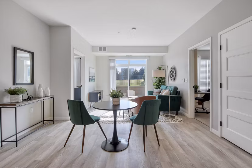 Dining area with modern furnishings at Arasan Apartments, featuring elegant lighting and open layout for Greystar luxury living