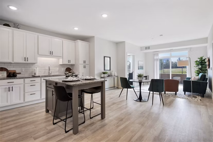 Modern kitchen featuring stainless steel appliances and granite countertops at Arasan Apartments